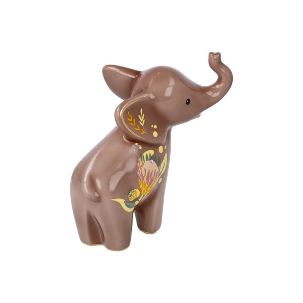 Goebel „Kiombo“ – Elephant de Luxe е изящна порцеланова фигура, вдъхновена от реалния осиротял слон Kiombo, за когото Goebel поема патронаж през 2022 г. Топлите тонове, деликатните растителни мотиви и фините кристални акценти превръщат 15,5-сантиметровата фигура в елегантен символ на сила, мъдрост и надежда. Част от приходите от серията Elephant подкрепят инициативи за защита и грижа за африканските слонове.